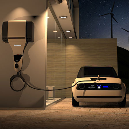 Pohled zepředu na koncept Honda Urban EV připojený k nabíjecímu zařízení