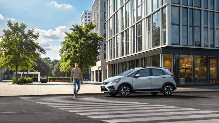 Dva vozy Honda Jazz zaparkované před kancelářskou budovou