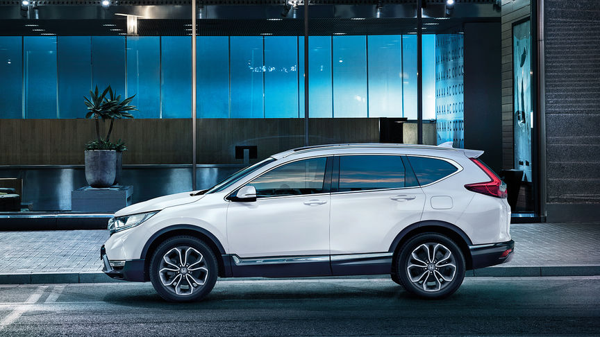 Tříčtvrtinový pohled zepředu na model CR-V při jízdě městem.