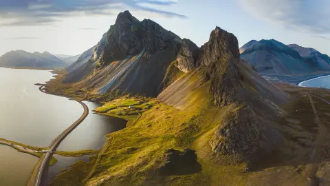 Malebná silnice na Islandu, krásná příroda, panorama z výšky, hory a pobřeží při západu slunce