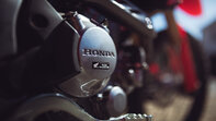 Honda Rider walking past Honda test ride stand
